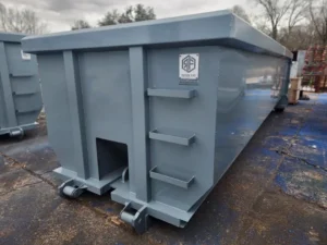 grey refuse fab roll off container at job site